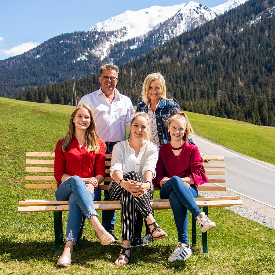 Das Bild zeigt Familie Klammer: Georg und Maria mit ihren drei Töchern vor alpinem Hintergrund.